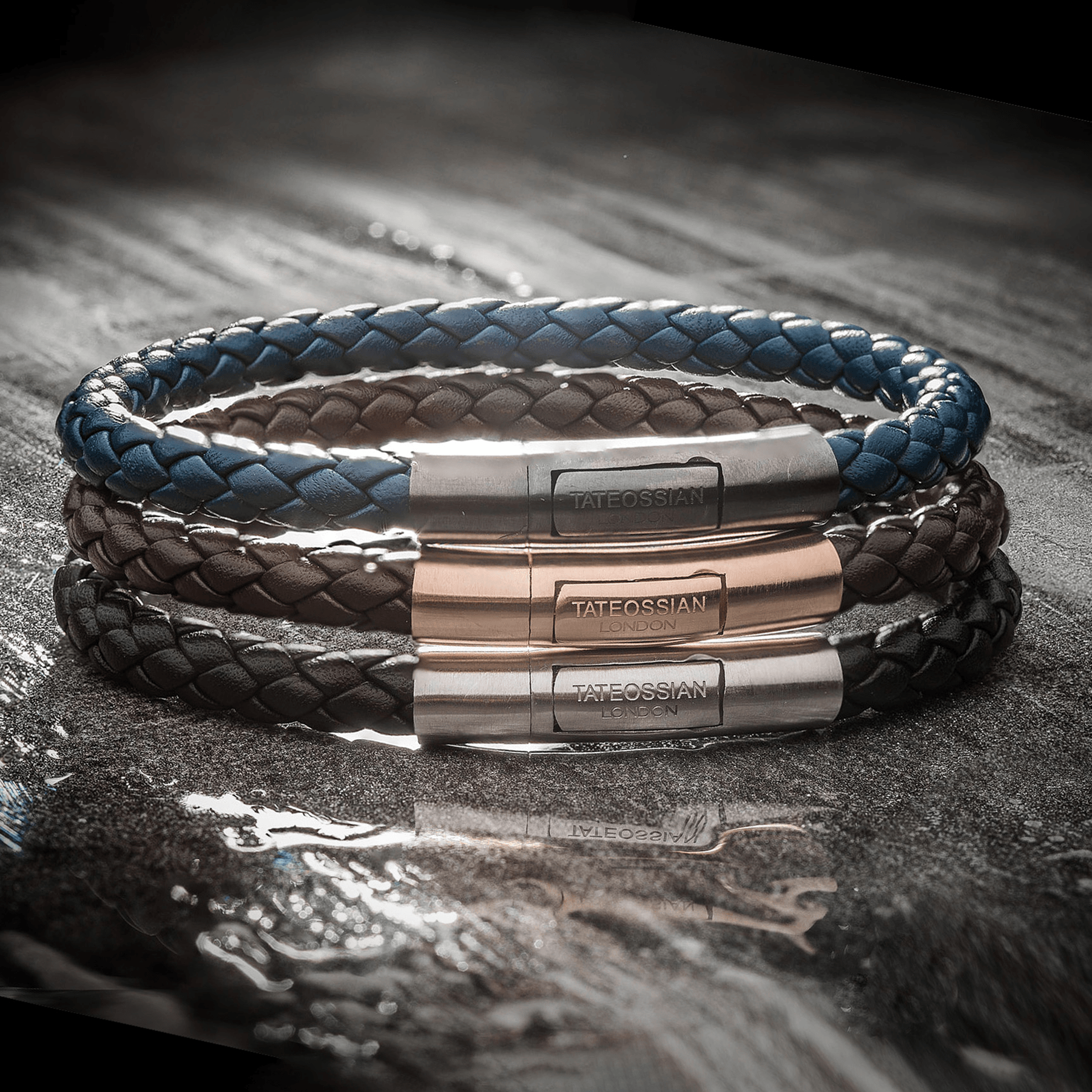 Charles Leather Bracelet In Black showing tightly woven Italian leather with a rhodium plated sterling silver clasp on a textured surface.