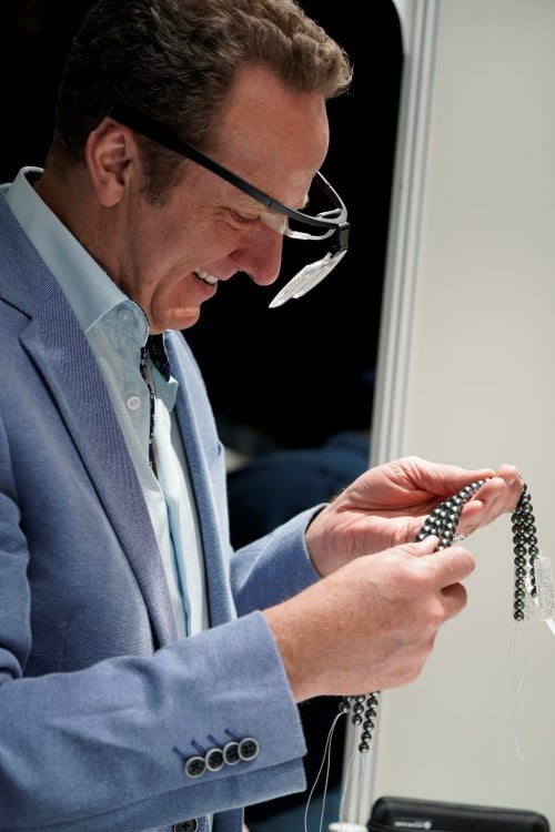 Jeremy Shepherd Examines strands of black pearls at the Hong Kong pearl show