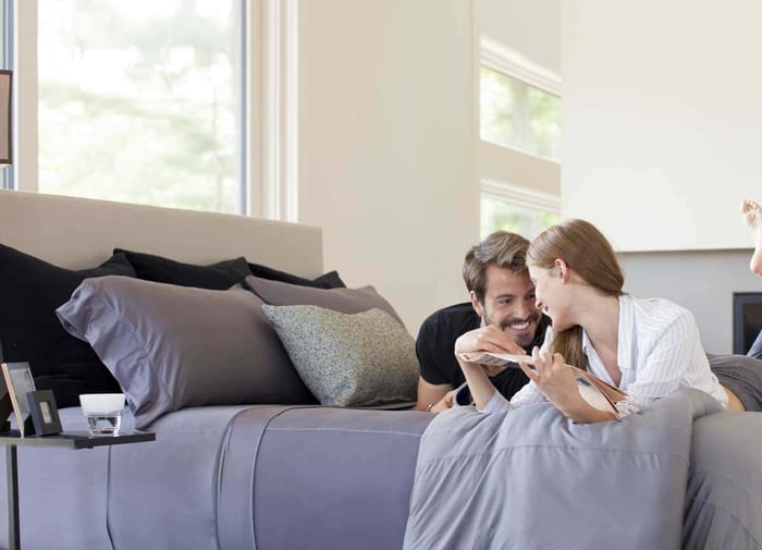 Couple Cuddled in their Temperature Regulating Bedding Sheets