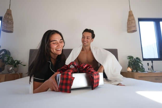 Couple Opening Up Gifts for the Holiday