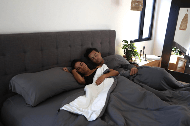 Couple Cuddled in Sheex Cooling Sheets During Labor Day Weekend