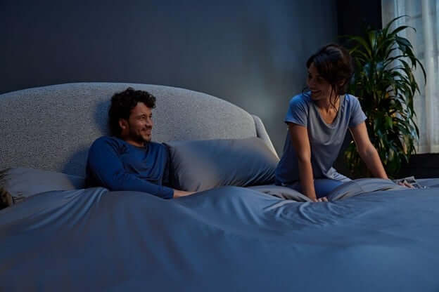 Man and Woman Getting into Bed to Have a Good Night Sleep