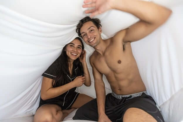 Man and Woman Under the Covers Wearing Cooling Sleepwear