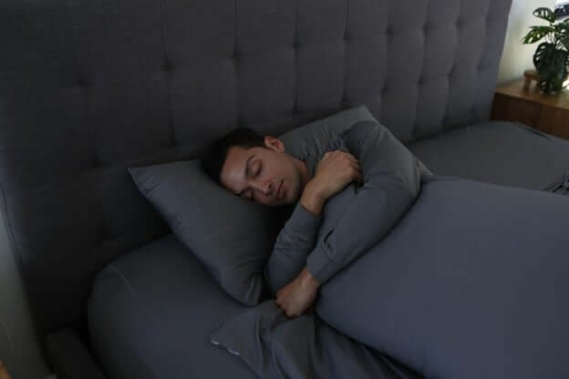 Man Hugging a Sheex Pillow in a Colder Room