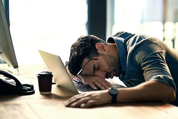 Man Sleeping on His Desk Because he's Tired