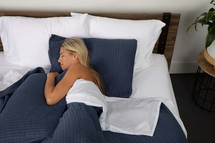 Woman Athlete Enjoying Her Sleep in SHEEX Cooling Duvet and Cooling Sheet Set