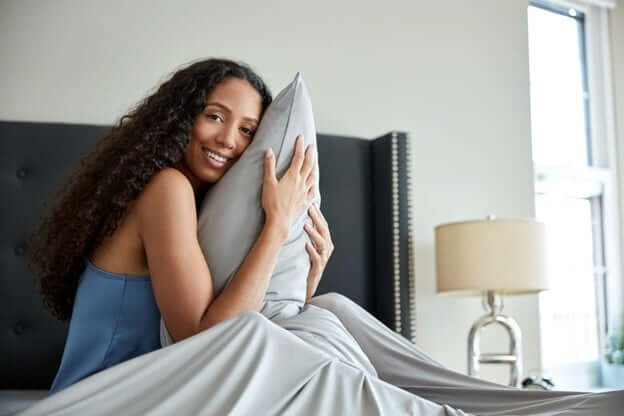 Woman Hugging a Pillow With a Cooling Pillowcase