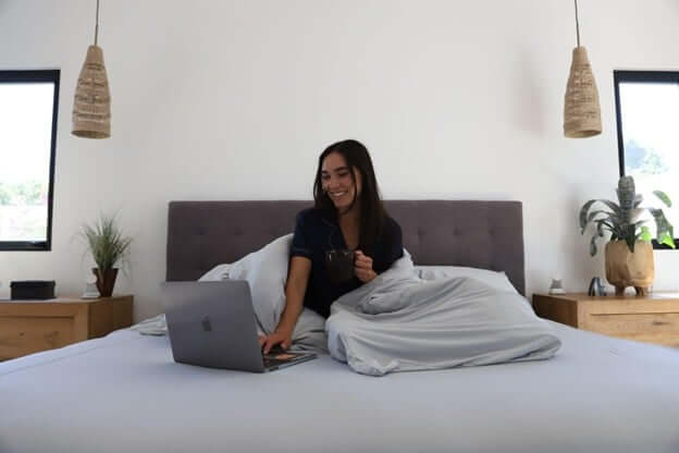 Woman Wearing Cooling Loungewear Laying in Bed