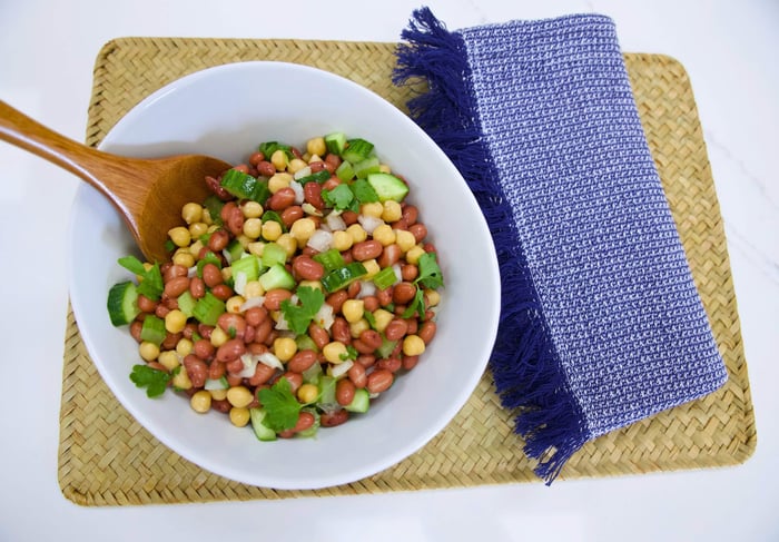 Bean salad with serving spoon inserted