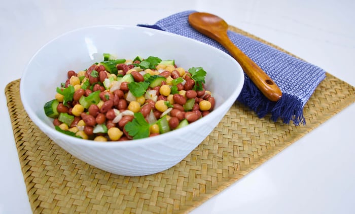 Bean salad with serving spoon out of bowl