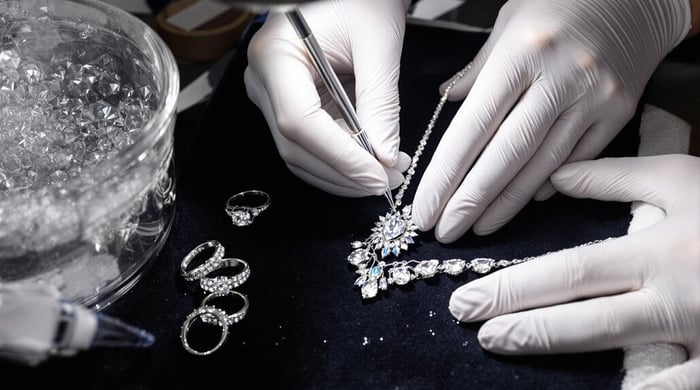 Diamond jewellery care - a diamond neckalce is eing carefully cleaned