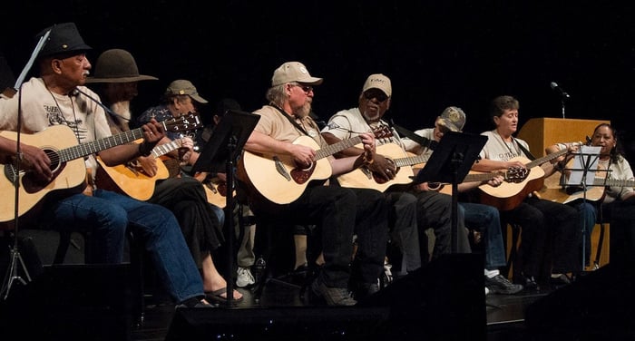 Guitars for vets on stage playing guitars