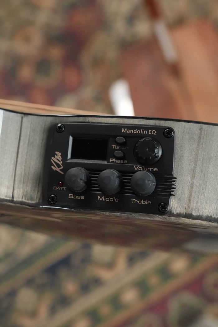KLOS Mandolin EQ preamp with tuner and bass, middle, treble and volume controls on a carbon fiber mandolin