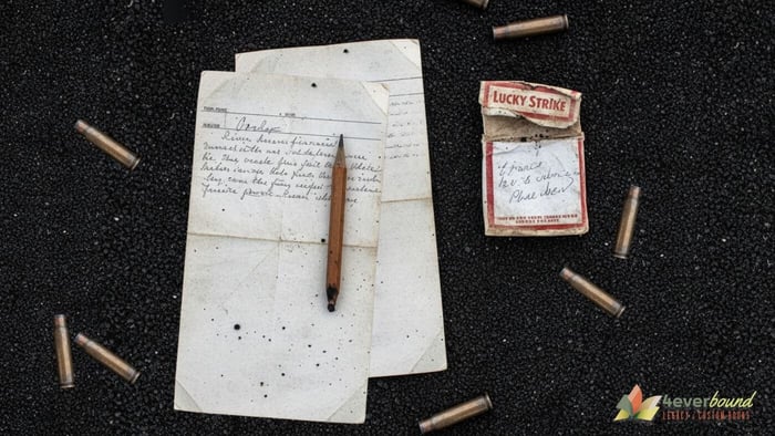 Vintage war letters writing supplies including V-mail forms and pencils on volcanic sand