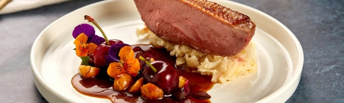 Duck with cherry and butterbean mash