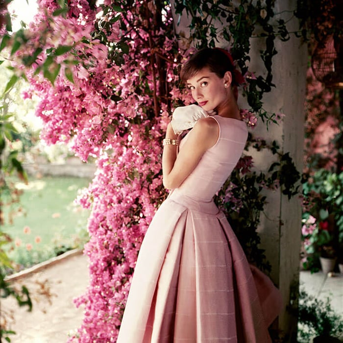 Audrey Hepburn models a Givenchy afternoon cocktail dress at Villa Rolli in 1955.