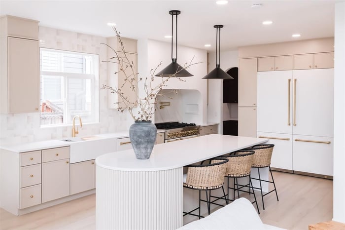 A cozy farmhouse-style kitchen with white and gold details.