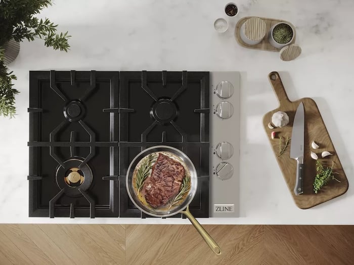 Cooktops vs. Rangetops: Gas cooktop with food in frying pan from above.