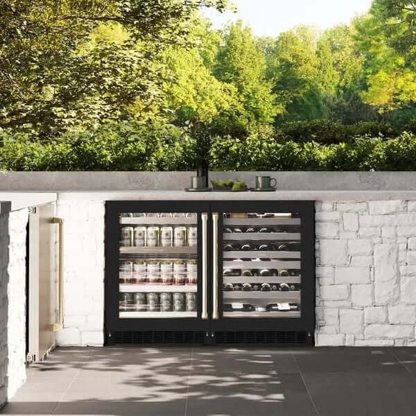 ZLINE Autograph Edition 24 in. Touchstone 151 Can Beverage Fridge With Black Matte Glass Door And Champagne Bronze Handle (RBSOZ-BLM-24-CB) installed on an outdoor patio