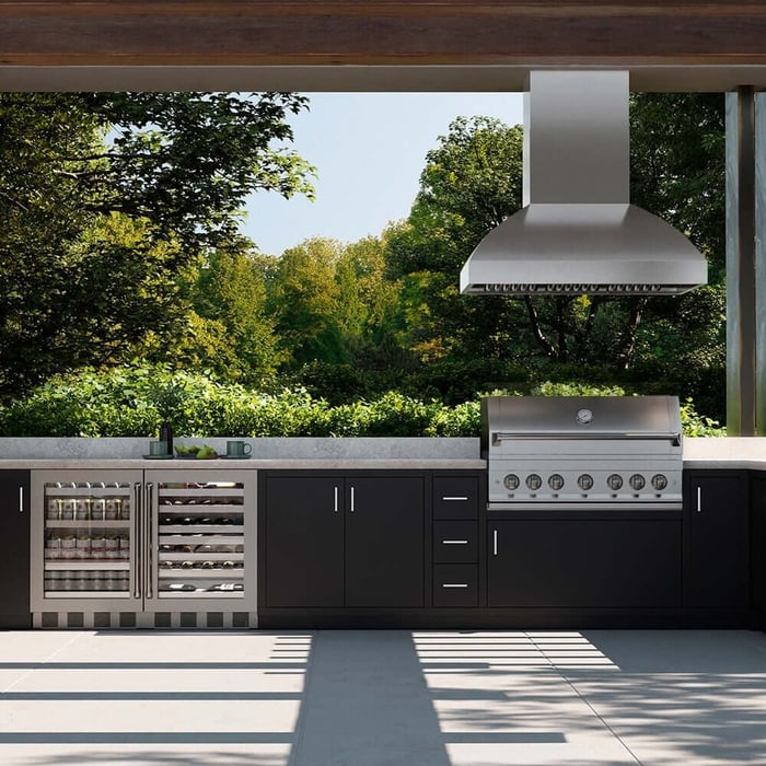 Stainless steel outdoor grill hood above bbq with matching wine and beverage coolers.