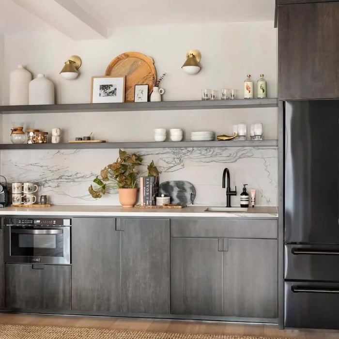 Black stainless appliances in a kitchen with dark wood details