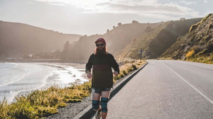 runner wearing knee sleeve for runners knee support while running