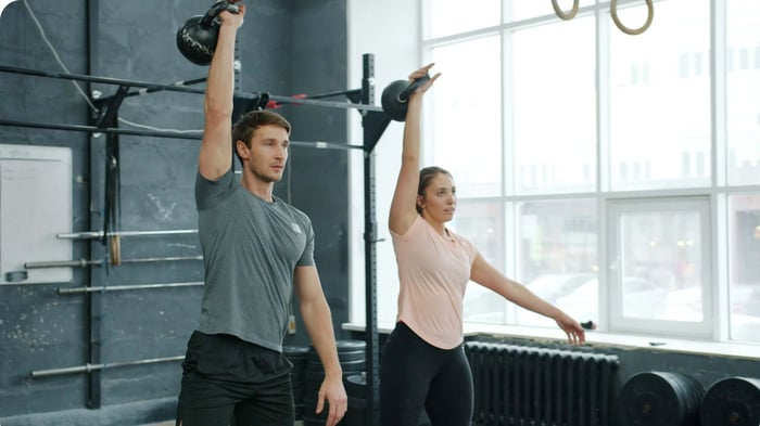 Athletes doing kettlebell training — kinesiology tape vs compression sleeve for daily training
