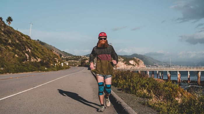 GO Sleeves partner running in GO Knee Sleeves, built for chronic training over acute vs chronic knee pain.