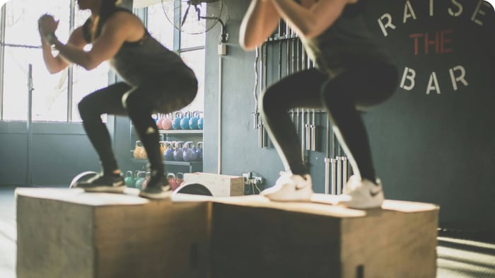 Athletes performing squats showing joint control and movement care