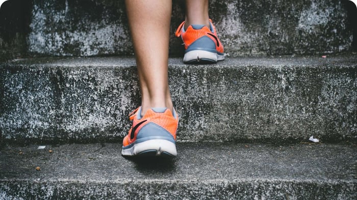 Person walking up stairs demonstrating balance and proprioception in everyday movement