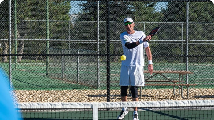 Rick Barry playing pickleball wearing knee and elbow sleeves