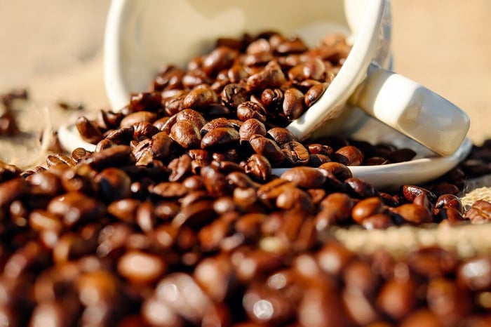 cup overflowing with coffee beans
