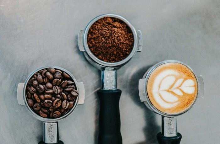 Coffee beans, ground, and espresso latte art.