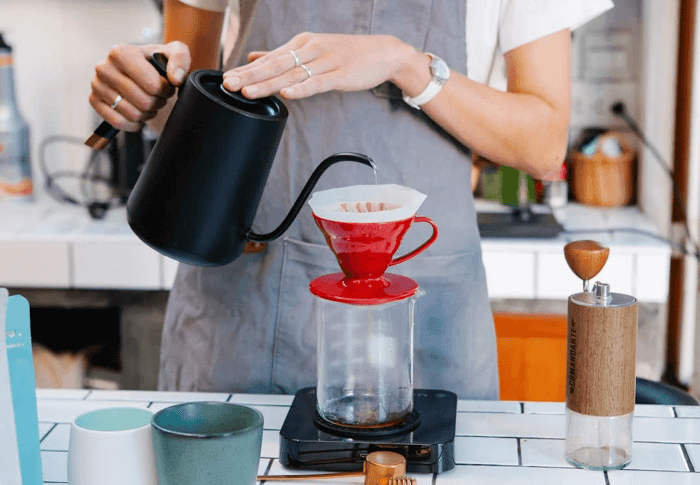 woman preparing coffee using pour-over method