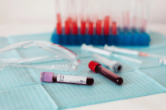 full vials of blood near medical equipment