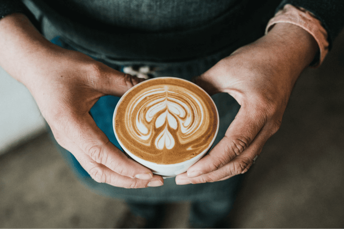 person holding cup of coffee