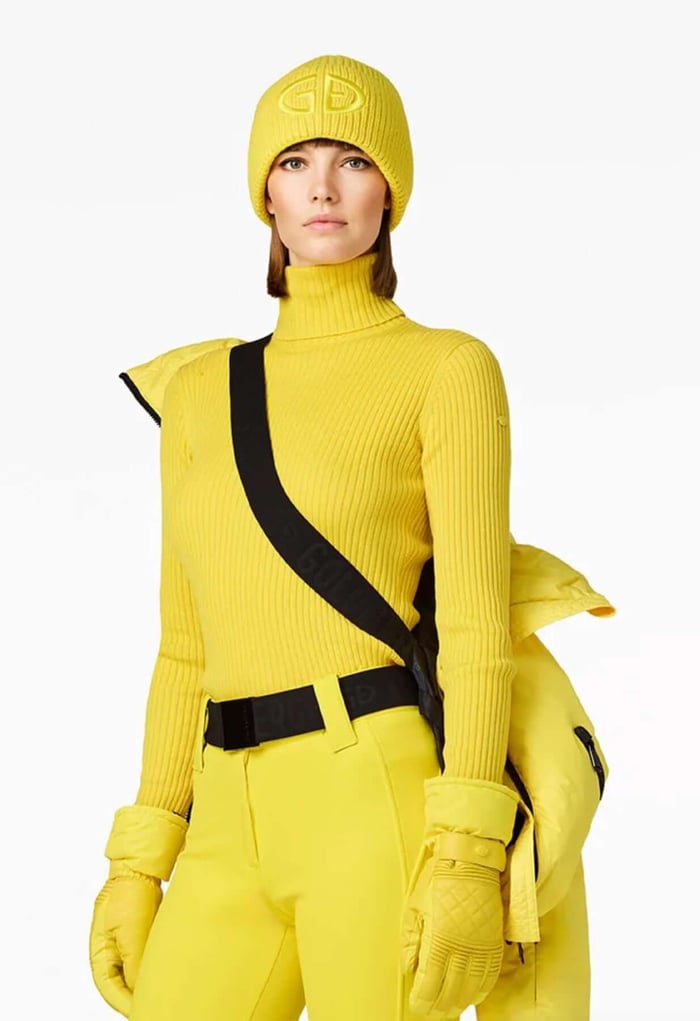 Bright yellow ski jacket Porter on a lady skier, perfect for spring skiing