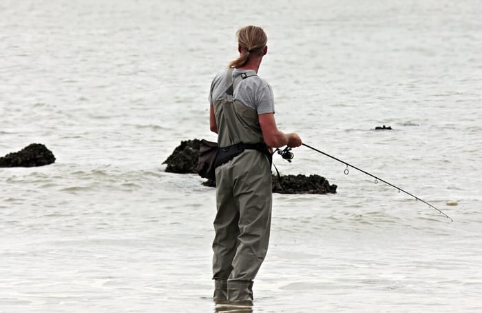 Man casually fishing by the sea
