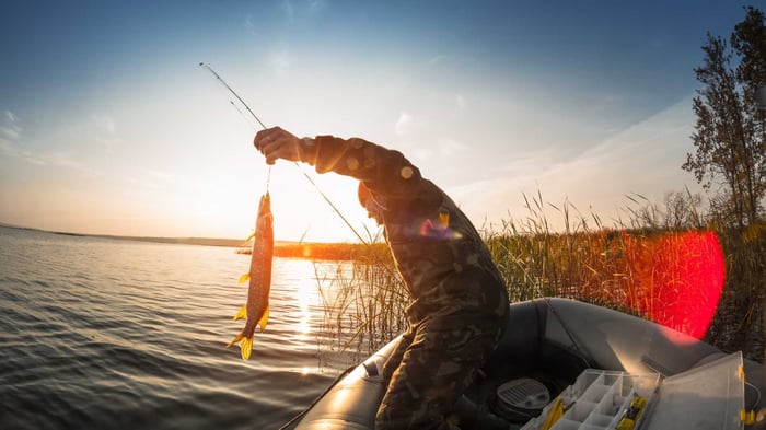 A man caught fish by boat fishing