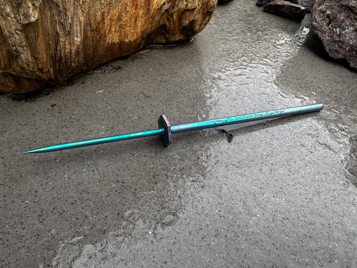 Teal colored titanium soldering pick. Created by Lion Punch Forge.