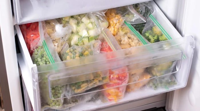 food prep meals with organized containers of hummus, vegetables, and protein prepared for balanced lunches