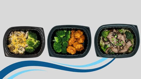Balanced macro meals displayed as three portioned black trays (protein + veggies + carbs) arranged in a clean, minimal layout with flowing blue accents.