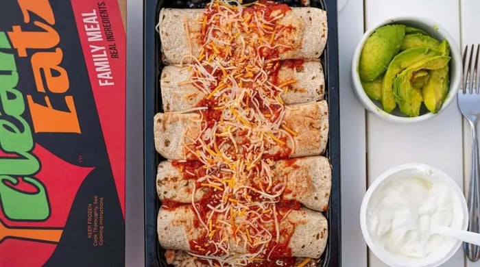 Best healthy prepared meal shown as family-style enchiladas topped with sauce and cheese, served with avocado and sour cream