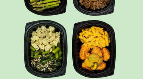 Best healthy ready-made meal delivery service shown with two complete entrée trays (protein + sides) photographed cleanly on a light background, emphasizing convenient, portion-controlled meals.