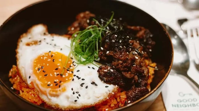 Easy barbacoa beef bowl served as beef fried rice with scallions and chopsticks on a white plate.