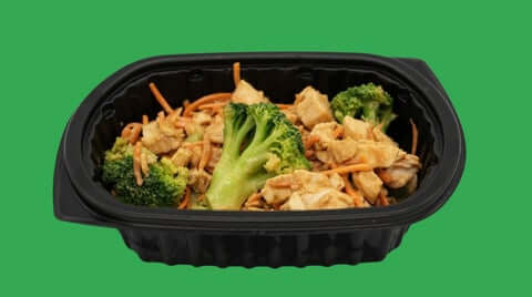 Healthy prepared meals for delivery shown as broccoli chicken stir-fry in black tray, ready-to-eat nutritious portion.