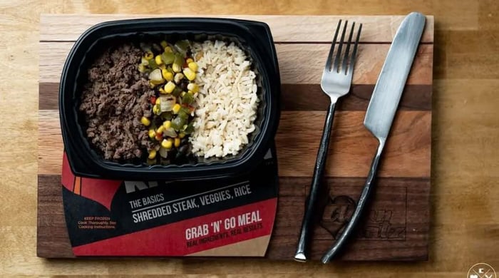 Macro-friendly meal of shredded steak, brown rice, and corn-and-pepper veggies in a Clean Eatz Kitchen Grab 'N' Go container.