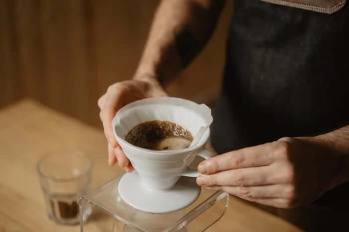 A barista making pour-over coffee
