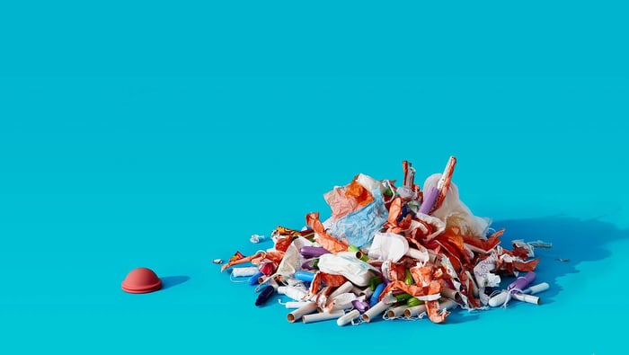  nixit menstrual disc next to a pile of used menstrual products