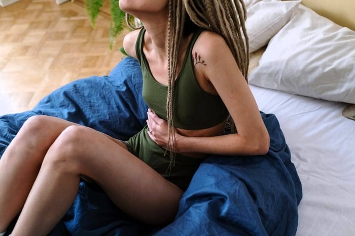 a young women experiencing period pain
